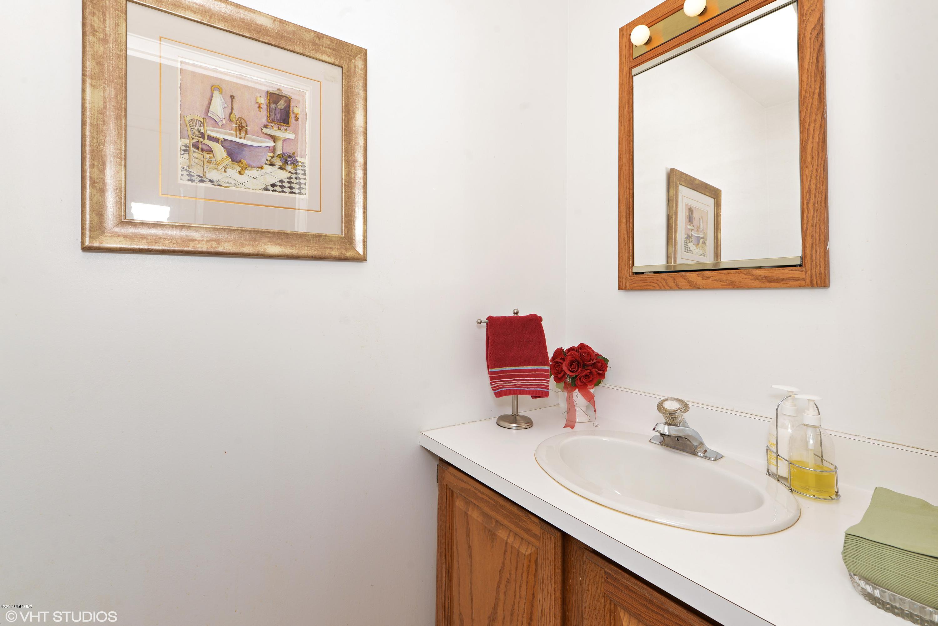 42 Ritch Avenue Greenwich, CT 06830 - Photo 14 of 32 a bathroom with a sink and a mirror