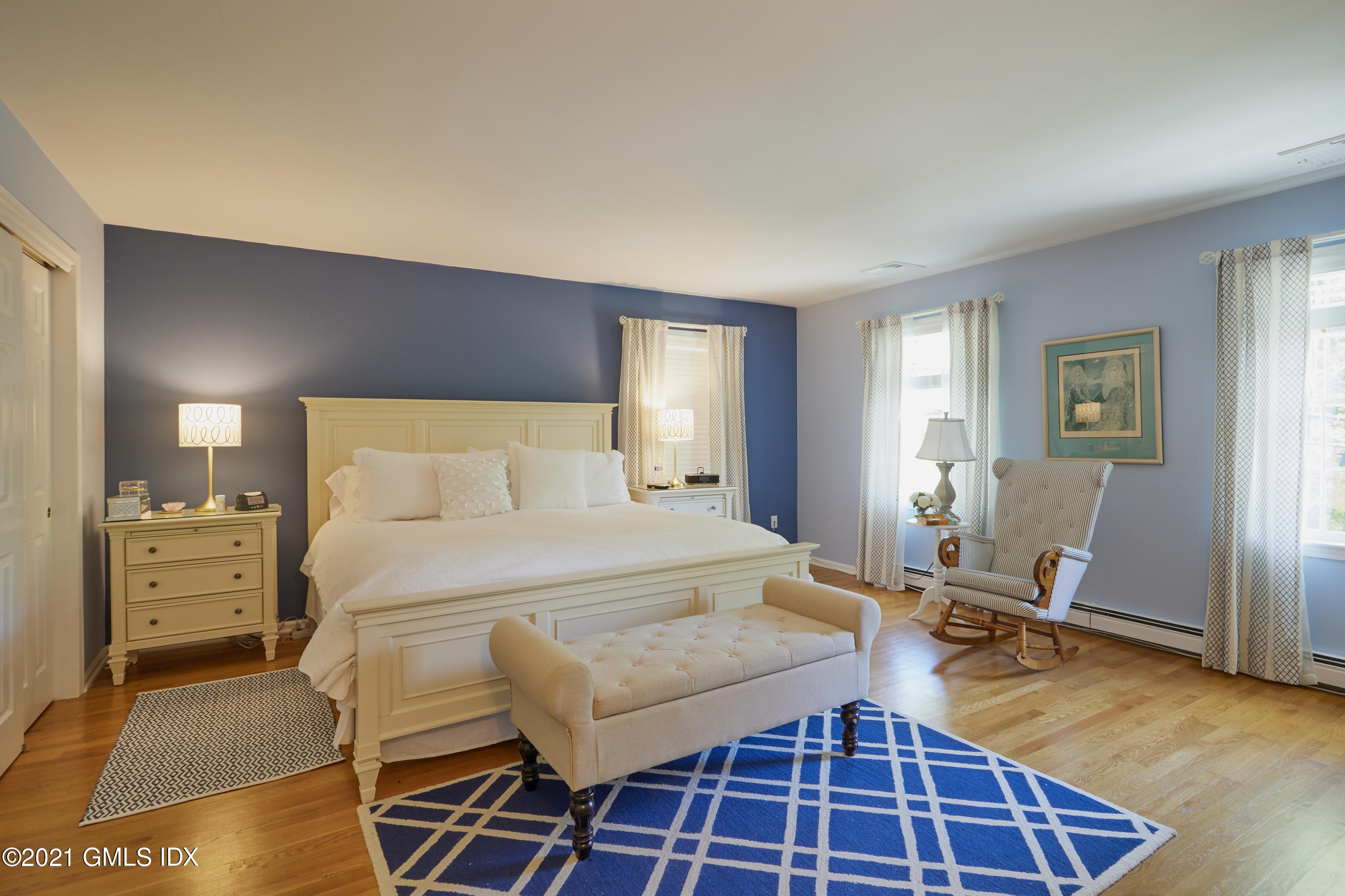 42 Ritch Avenue Greenwich, CT 06830 - Photo 17 of 32 a bedroom with a bed and wooden floor