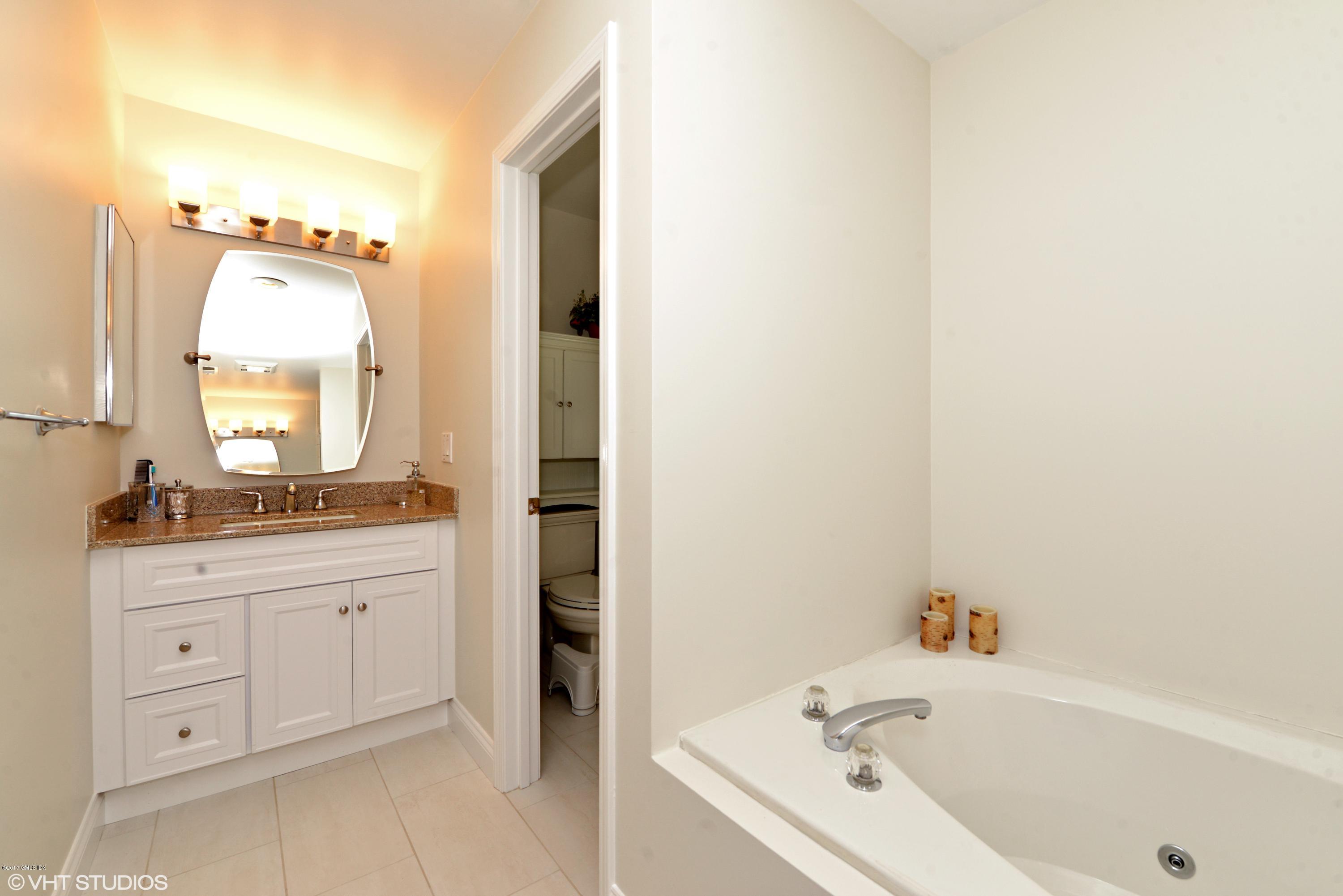 42 Ritch Avenue Greenwich, CT 06830 - Photo 19 of 32 a bathroom with a tub sink and mirror