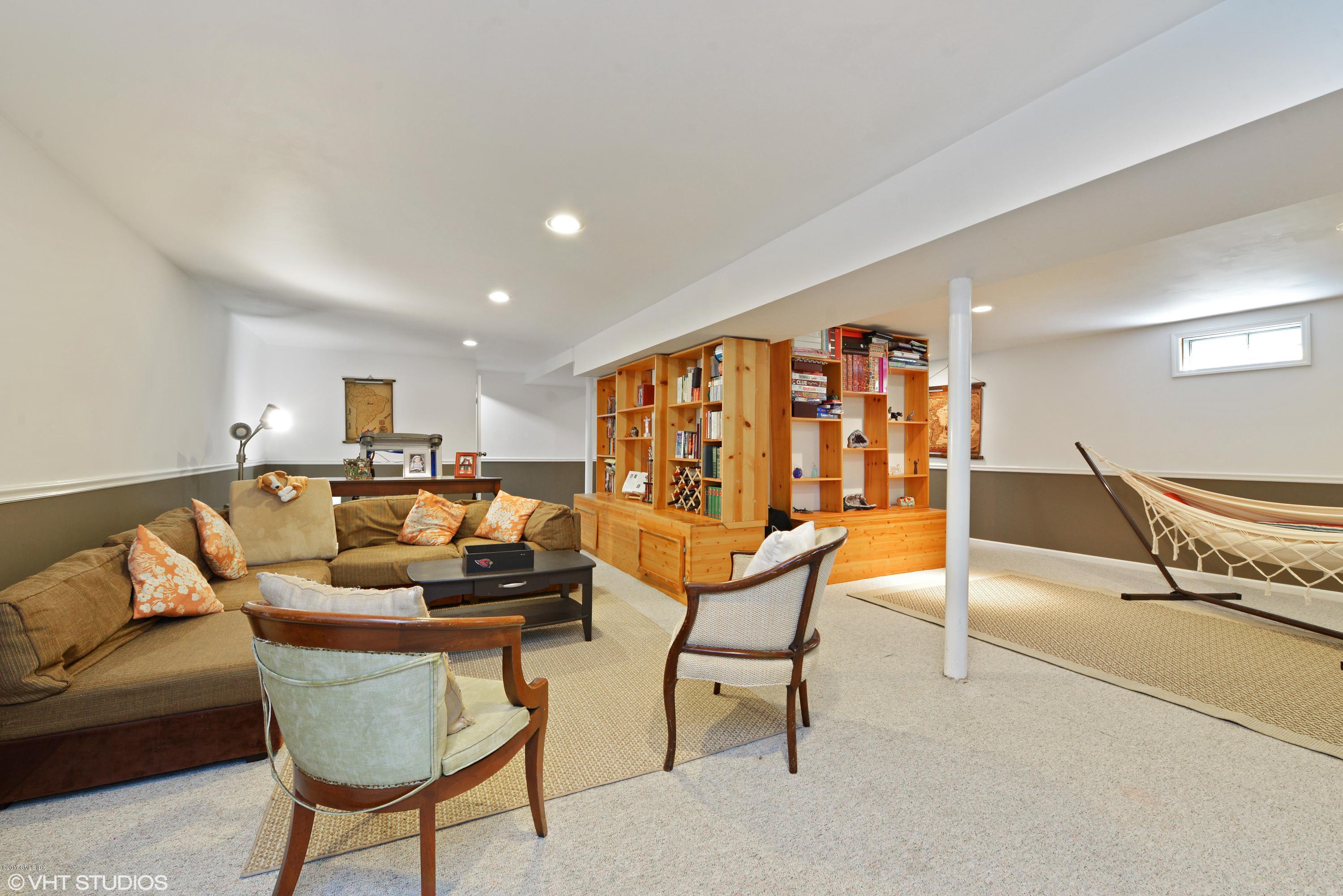 42 Ritch Avenue Greenwich, CT 06830 - Photo 27 of 32 a living room with furniture and a book shelf