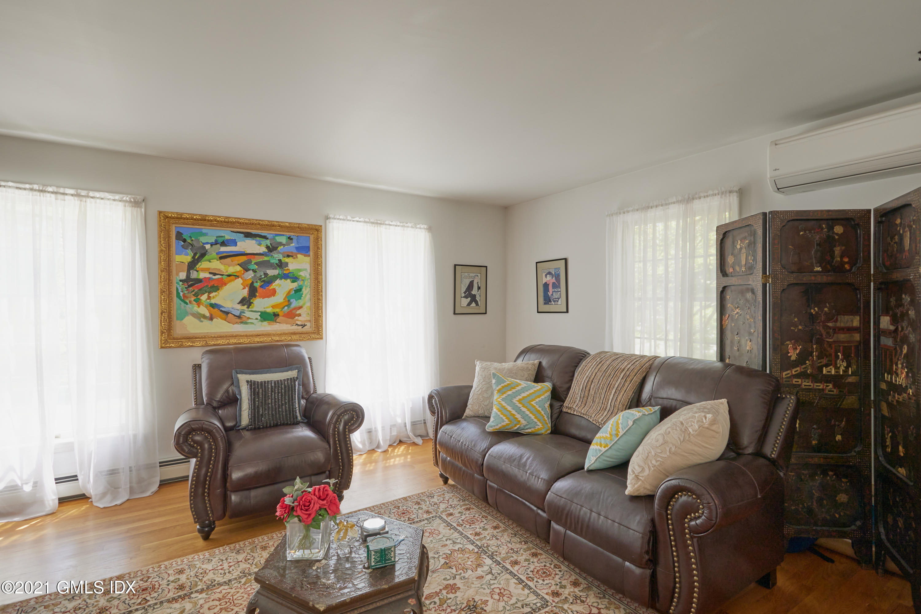 42 Ritch Avenue Greenwich, CT 06830 - Photo 7 of 32 a living room with furniture a couch and a bookshelf