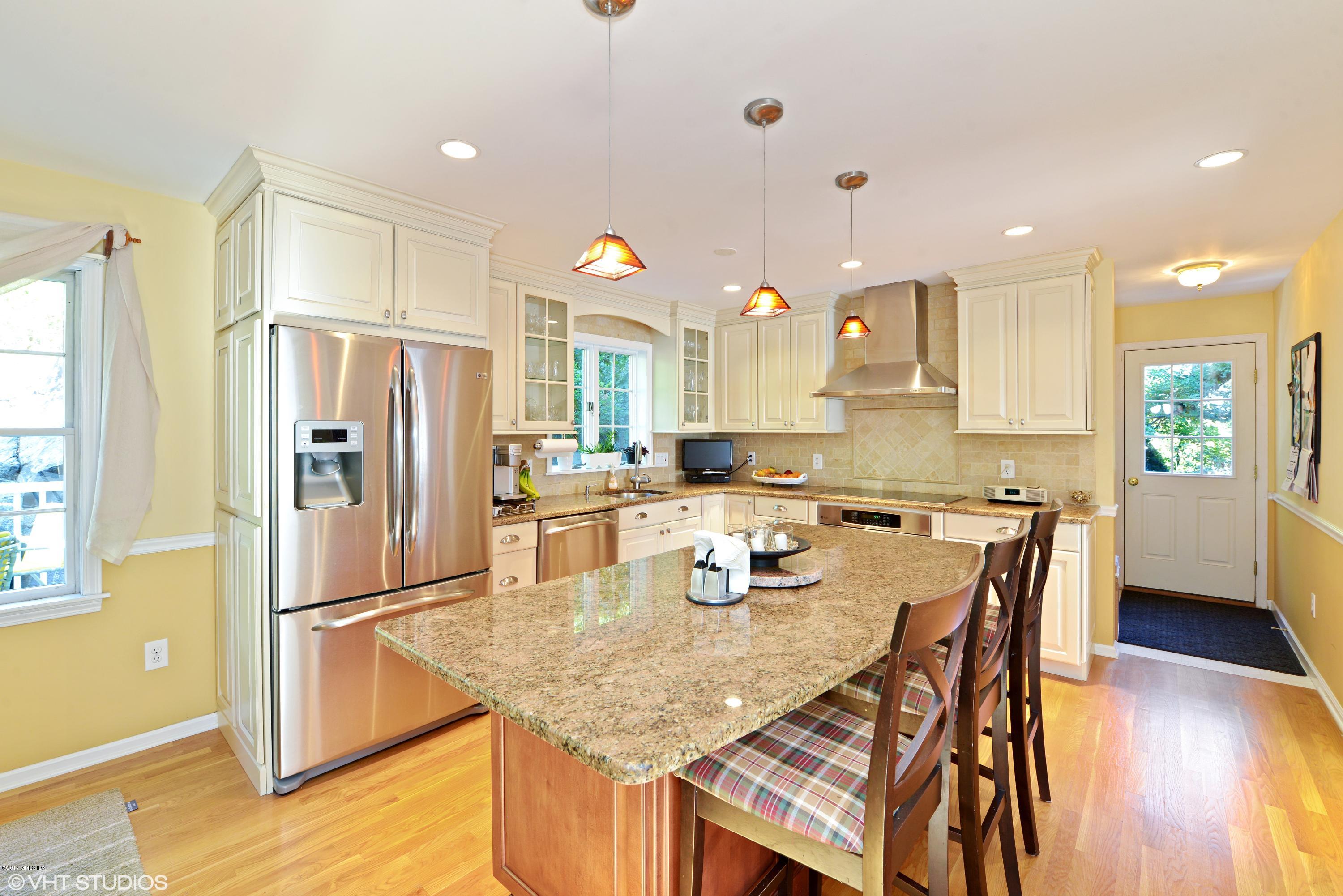 42 Ritch Avenue Greenwich, CT 06830 - Photo 10 of 32 a kitchen with stainless steel appliances granite countertop a refrigerator a microwave and wooden floor