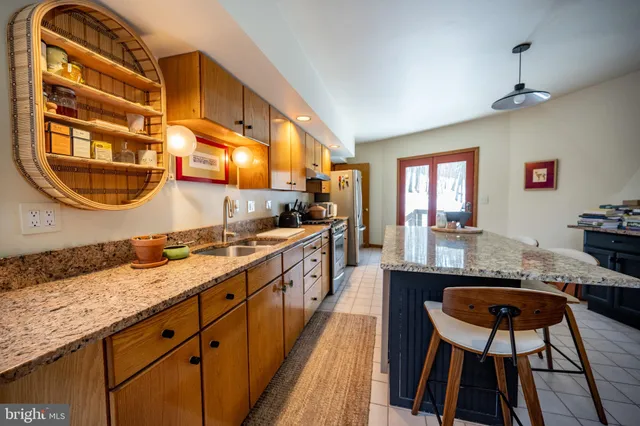 a living room with furniture a flat screen tv and a potted plant