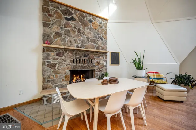 a living room with furniture a fireplace and a large window
