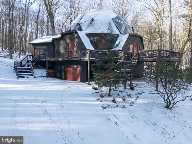a view of a chairs and table in the backyard