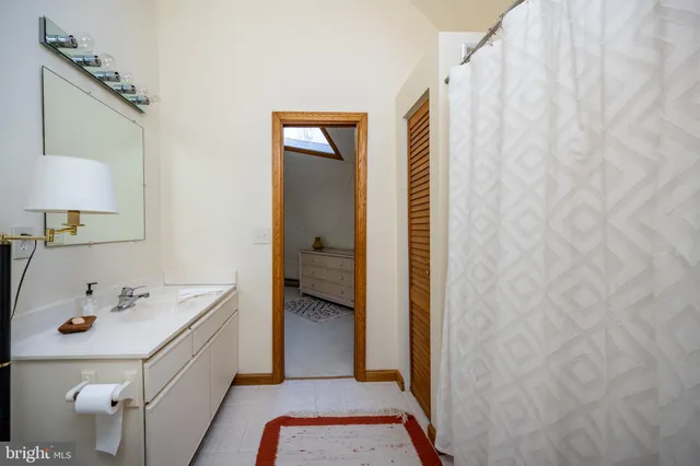 a bathroom with a toilet a sink and a mirror