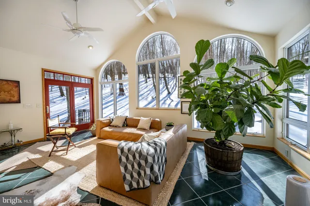 a view of a livingroom with furniture and a ceiling fan