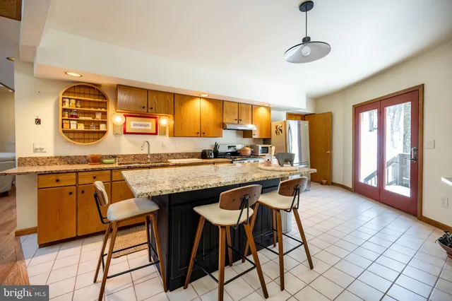a living room with fireplace furniture and a wooden floor