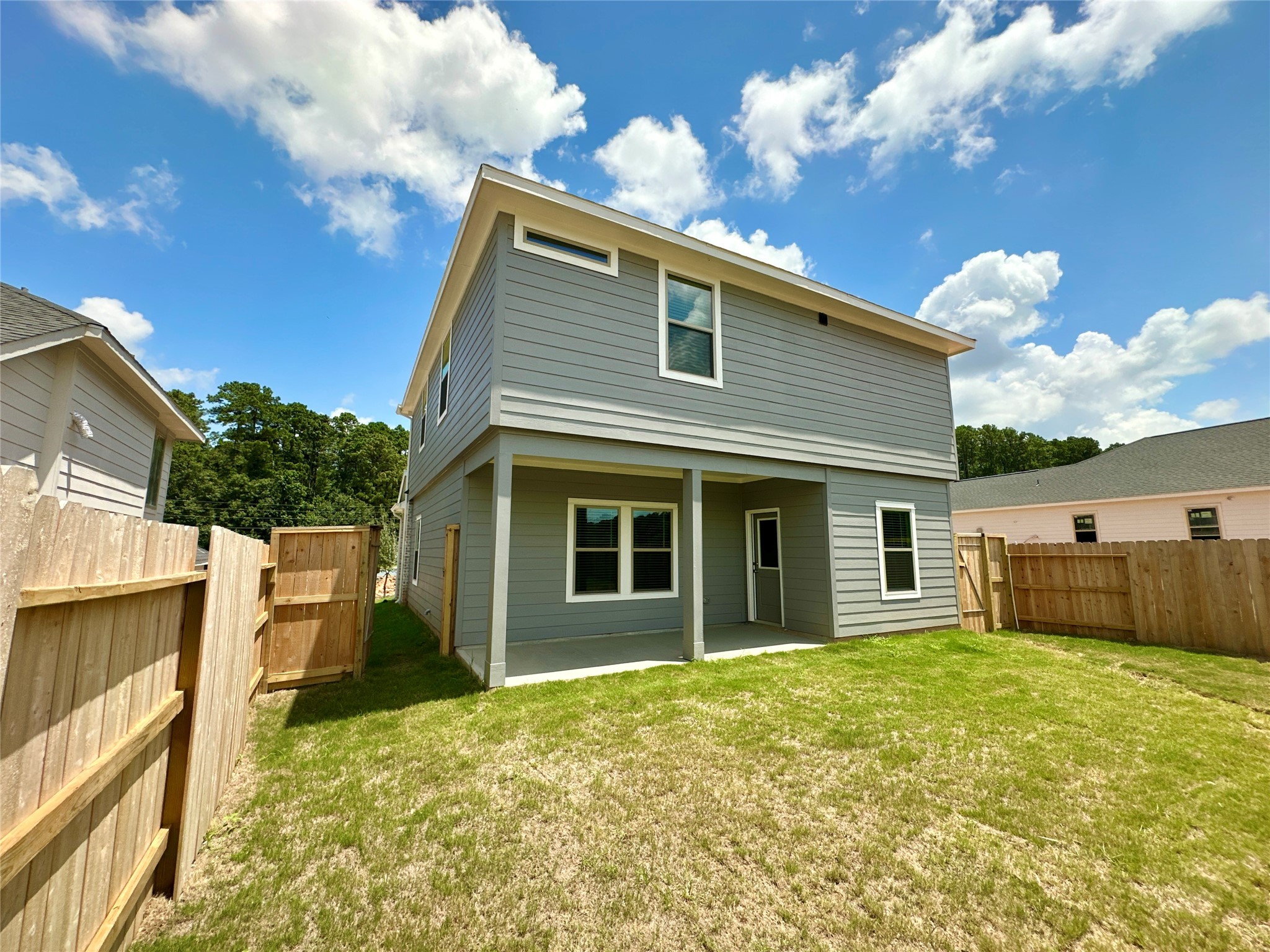 12176 Ridge Top Drive Conroe, TX 77304 - Photo 17 of 27 a view of a house with a large window and a yard