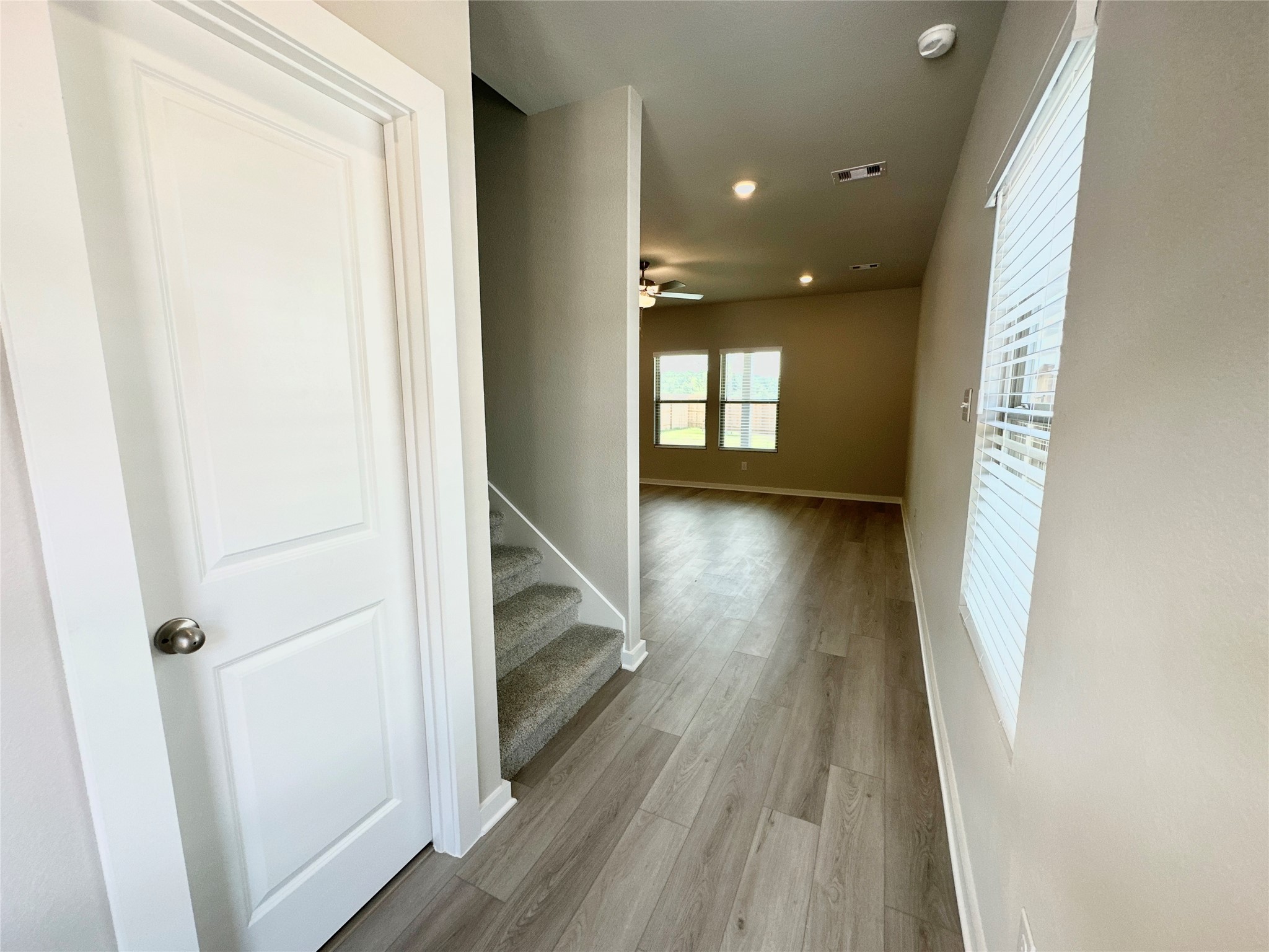 12176 Ridge Top Drive Conroe, TX 77304 - Photo 4 of 27 a view of hallway with wooden floor and stairs