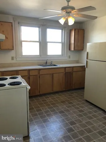 a kitchen with a sink cabinets and window