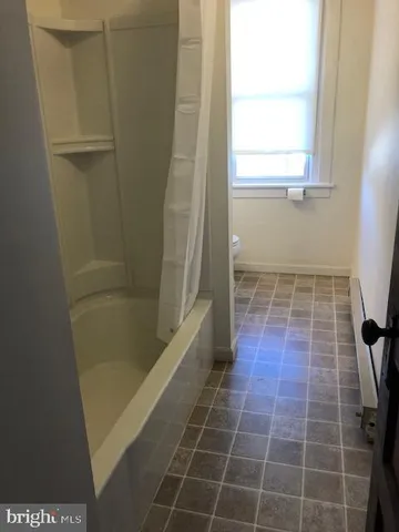 a bathroom with a glass door shower