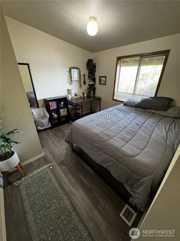 a bedroom with a bed gym equipment and a window