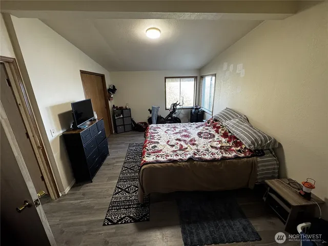 a bed sitting in a bedroom next to a window