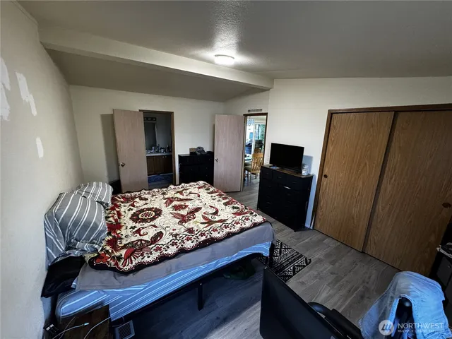 a bedroom with a bed and a television