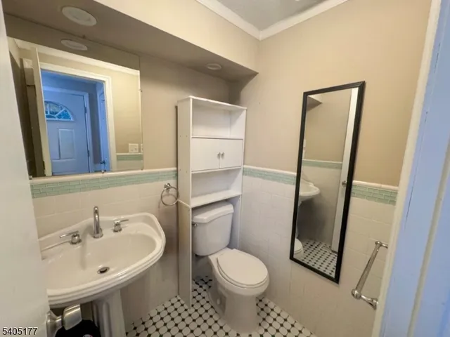 a bathroom with a sink toilet and mirror
