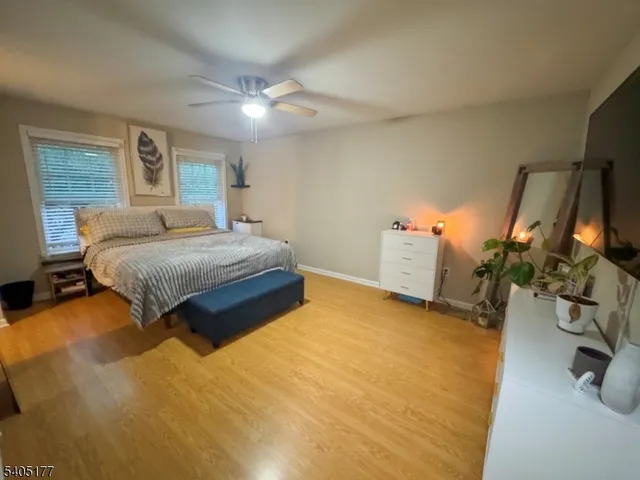 a bedroom with a bed and ceiling fan