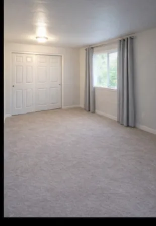 a view of an empty room with a window