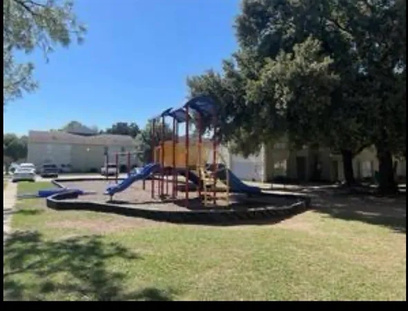 a front view of house and yard with beautiful flowers and green space