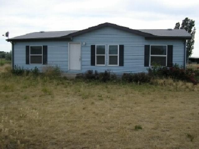 180 Bus Road Mabton, WA 98935 - Photo 1 of 5 a front view of a house with garden