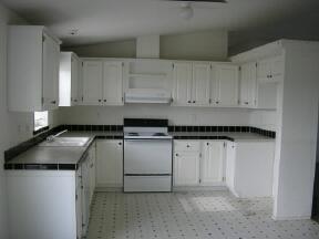 180 Bus Road Mabton, WA 98935 - Photo 2 of 5 a kitchen with stainless steel appliances granite countertop a sink a stove and a refrigerator