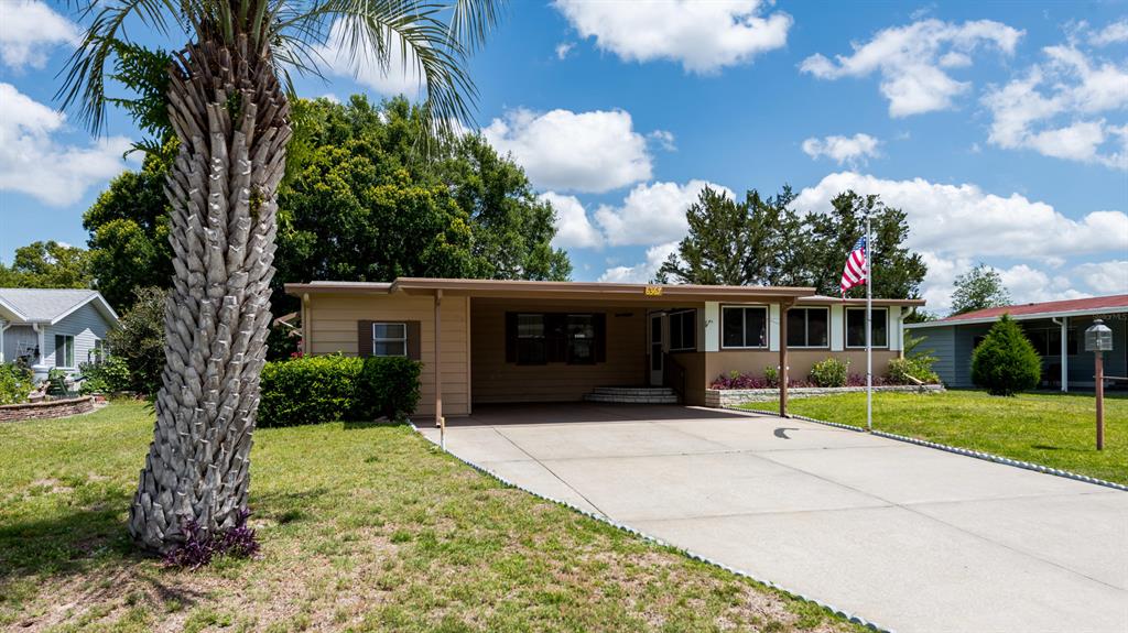 6367 Southwest 83rd Place Ocala, FL 34476 - Photo 1 of 1 a front view of a house with a yard and garage