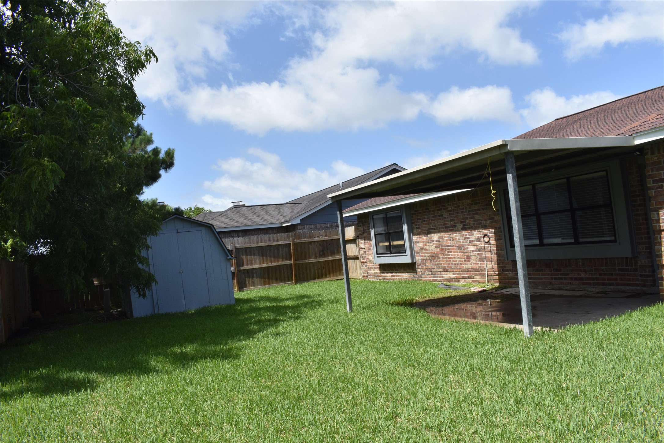 1347 Somercotes Lane Channelview, TX 77530 - Photo 26 of 30 a backyard of a house with lots of green space and garden