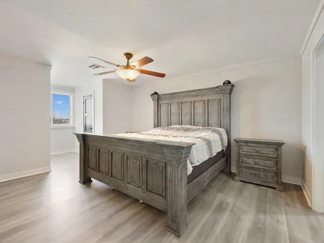 a bed room with a bed and a ceiling fan