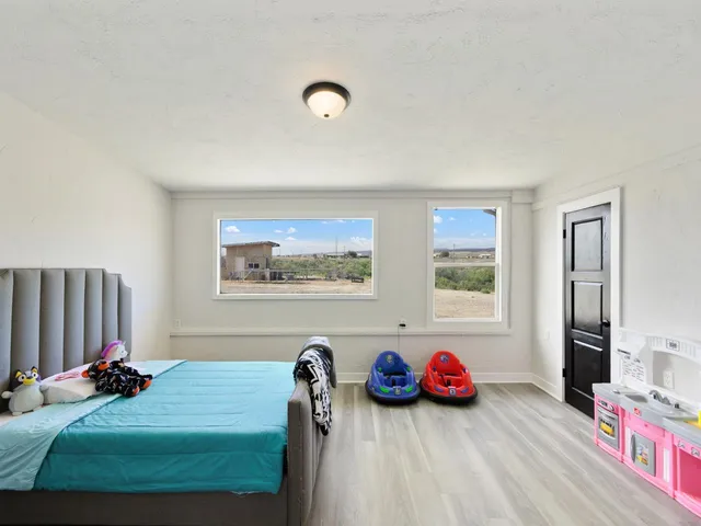 a view of a room that has a bed and a dresser in it