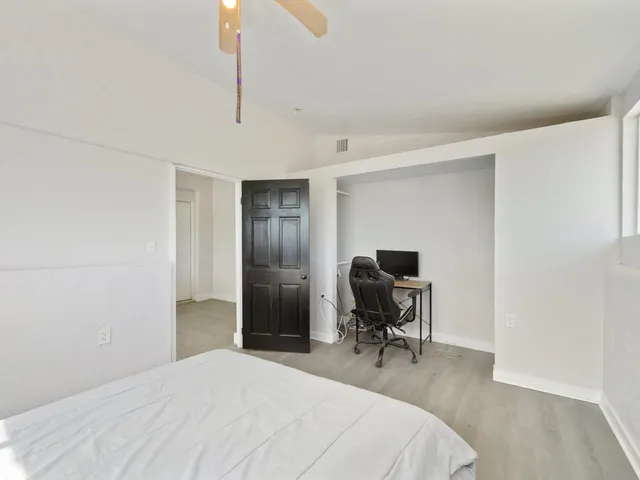 a bedroom with a bed and a chair