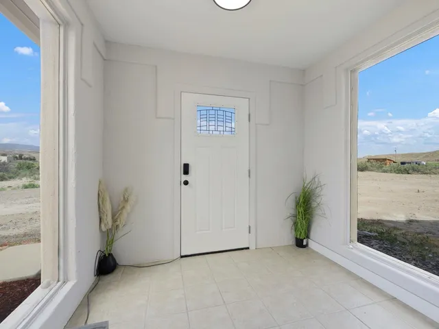 a view of an empty room and a window