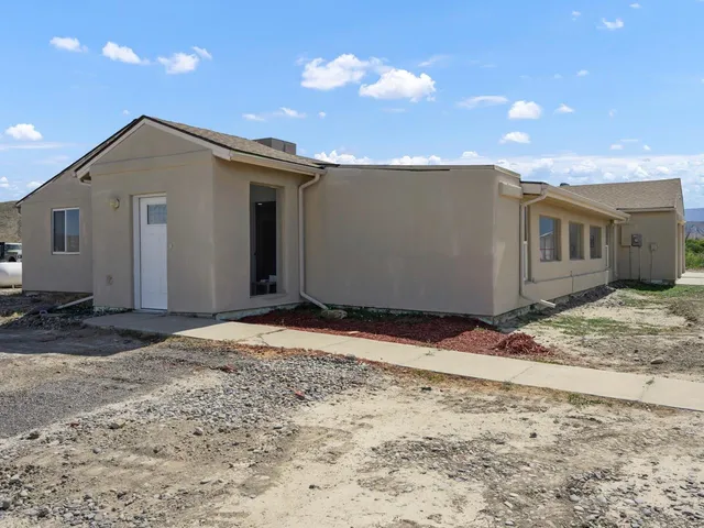a view of a house with a backyard