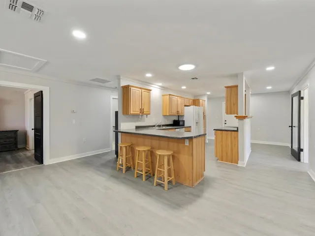 a view of kitchen with refrigerator cabinets and a counter top