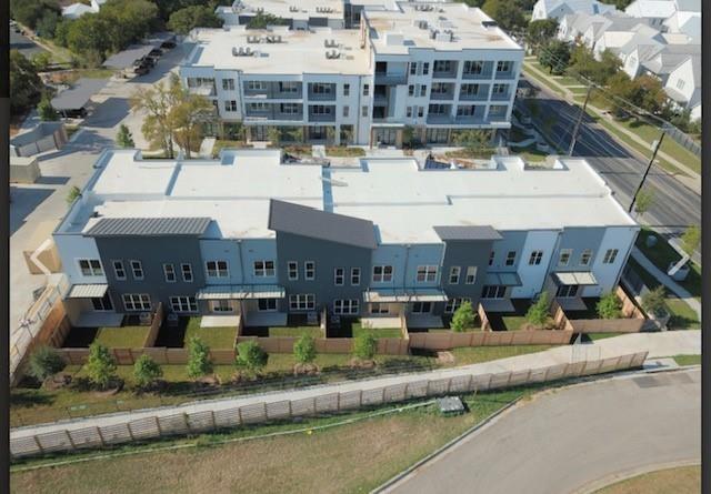 4801 Springdale Road, Unit 2211 Austin, TX 78723 - Photo 3 of 19 Modern townhomes featuring private fenced yards and sleek architectural lines.