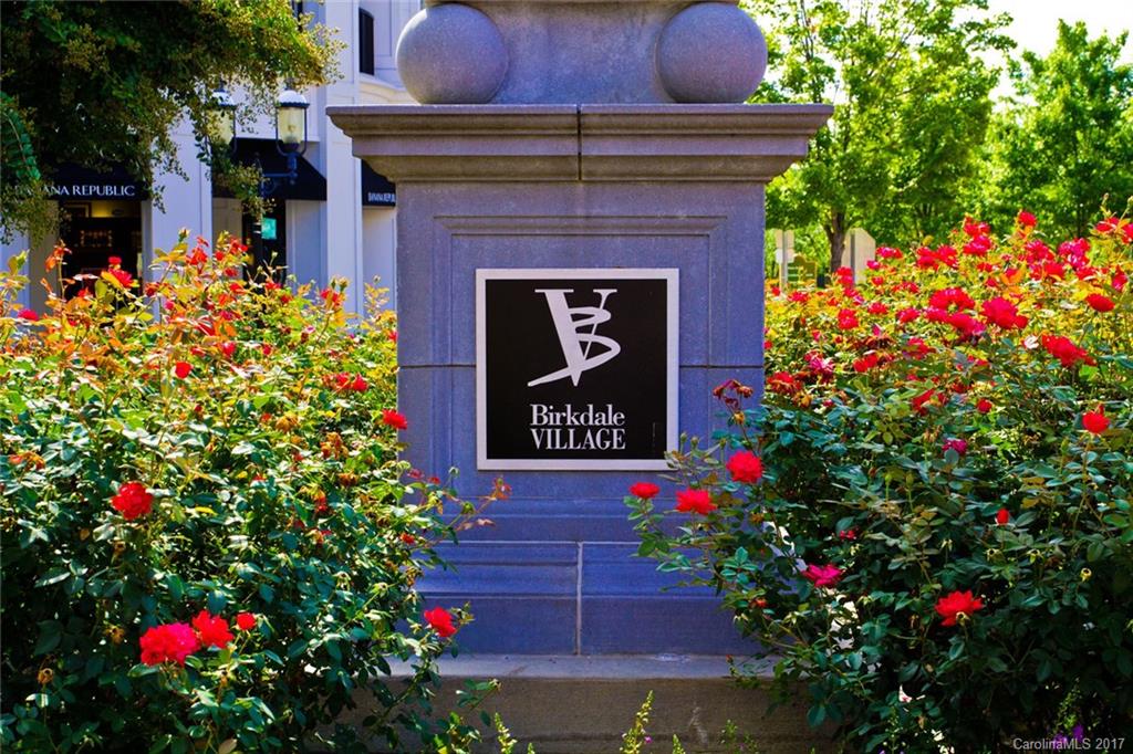 a sign that is in front of flowers