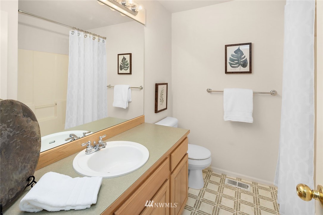 3002 204th Street Southeast Bothell, WA 98021 - Photo 22 of 27 a bathroom with a sink and a mirror