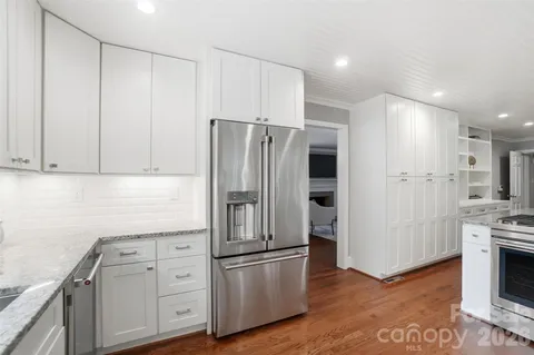 a kitchen with stainless steel appliances a refrigerator sink and cabinets