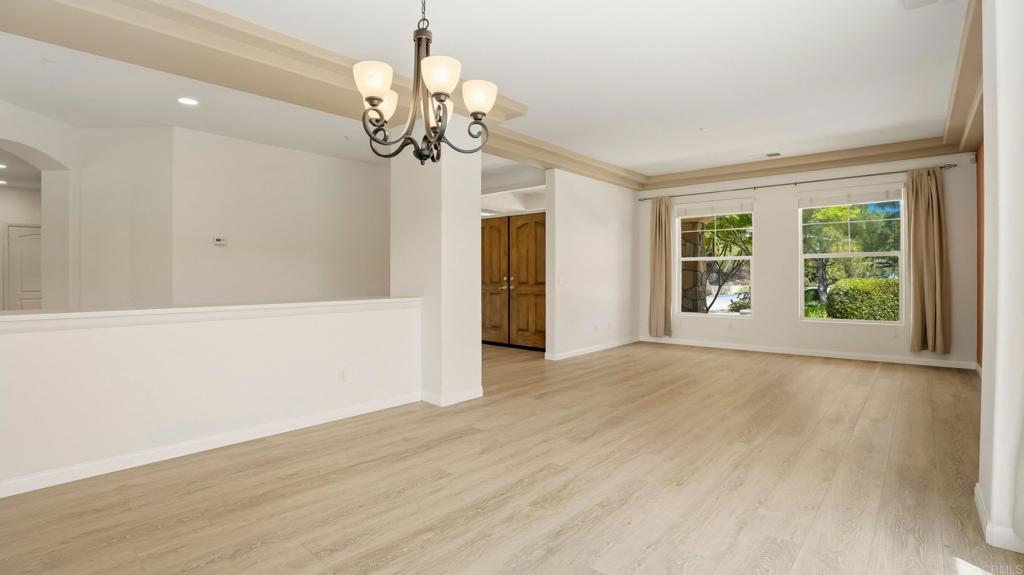 2527 Southern Oak Road Ramona, CA 92065 - Photo 16 of 56 a view of a livingroom with a chandelier fan and windows
