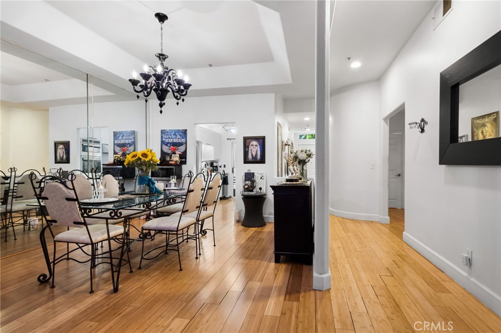 10626 Valley Spring Lane, Unit 103 Toluca Lake, CA 91602 - Photo 11 of 44 a view of a dining room with furniture and wooden floor