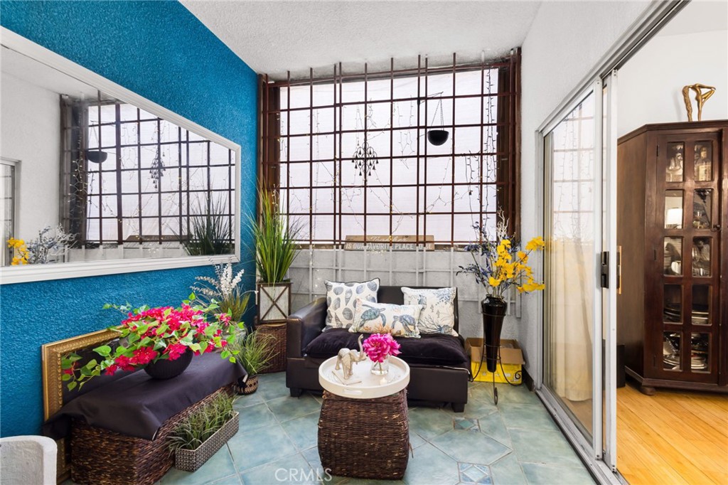 10626 Valley Spring Lane, Unit 103 Toluca Lake, CA 91602 - Photo 25 of 44 a living room with furniture and flowers