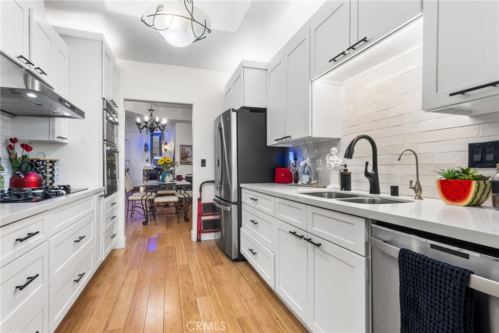 10626 Valley Spring Lane, Unit 103 Toluca Lake, CA 91602 - Photo 3 of 44 a kitchen with sink refrigerator and cabinets