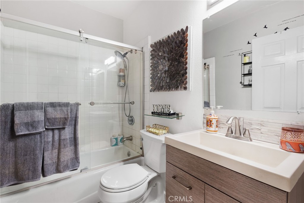 10626 Valley Spring Lane, Unit 103 Toluca Lake, CA 91602 - Photo 34 of 44 a bathroom with a sink a toilet a mirror and shower