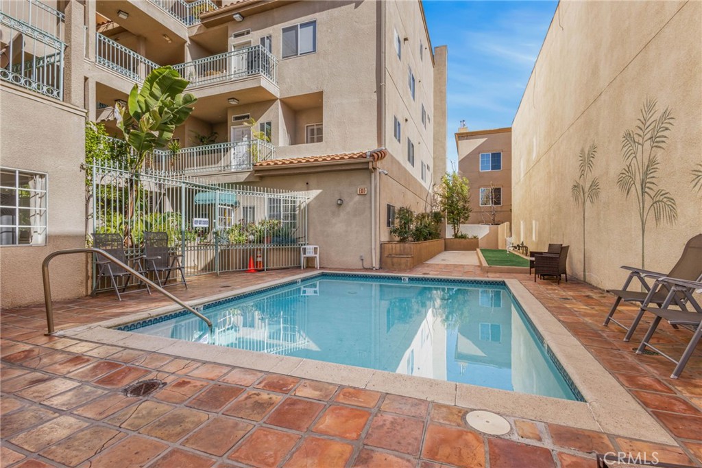 10626 Valley Spring Lane, Unit 103 Toluca Lake, CA 91602 - Photo 37 of 44 a view of a swimming pool with a patio