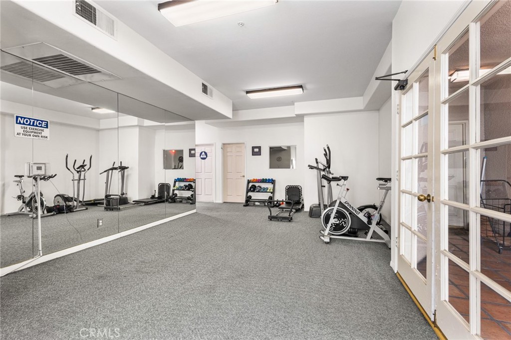 10626 Valley Spring Lane, Unit 103 Toluca Lake, CA 91602 - Photo 39 of 44 a view of a room with gym equipment