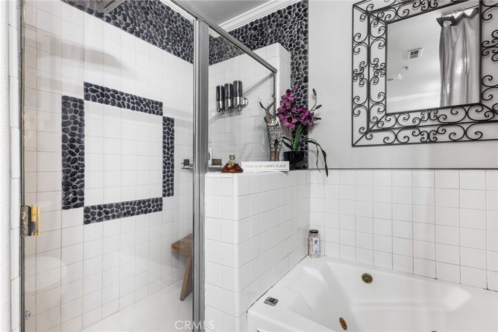 10626 Valley Spring Lane, Unit 103 Toluca Lake, CA 91602 - Photo 39 of 67 a bathroom with a bathtub and shower
