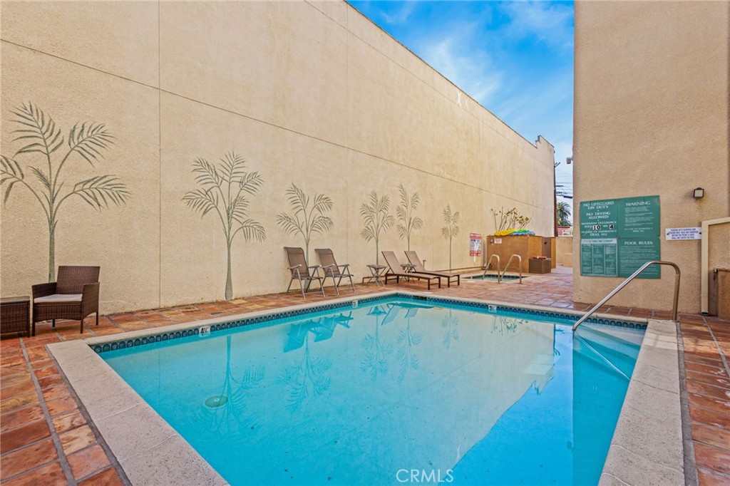 10626 Valley Spring Lane, Unit 103 Toluca Lake, CA 91602 - Photo 50 of 67 a view of a swimming pool with a yard