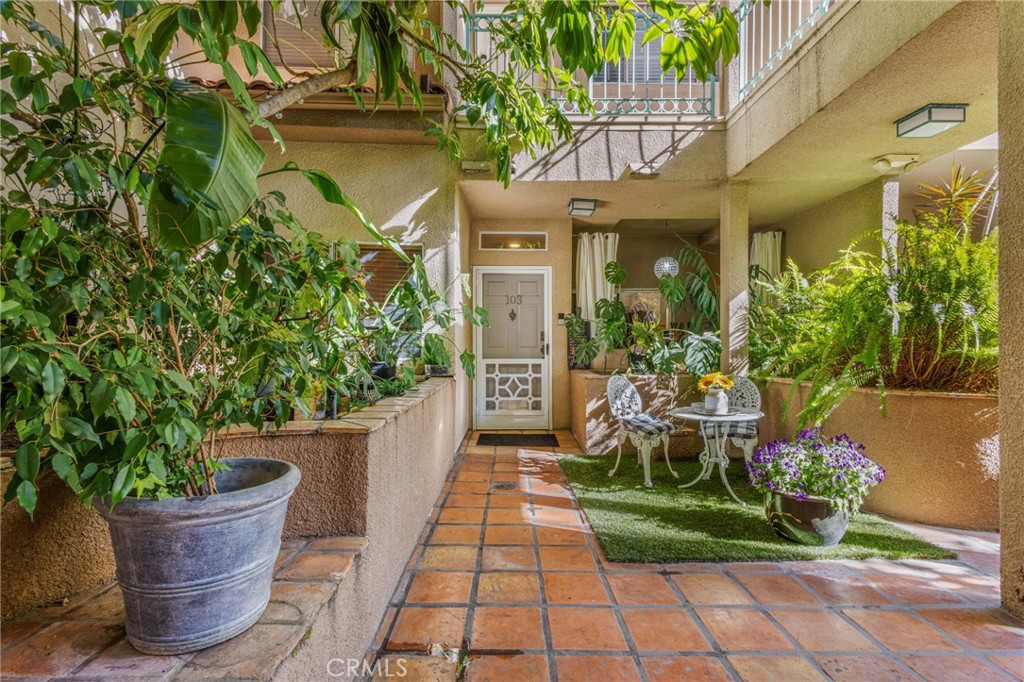 10626 Valley Spring Lane, Unit 103 Toluca Lake, CA 91602 - Photo 63 of 67 a front view of a house with lots of potted plants
