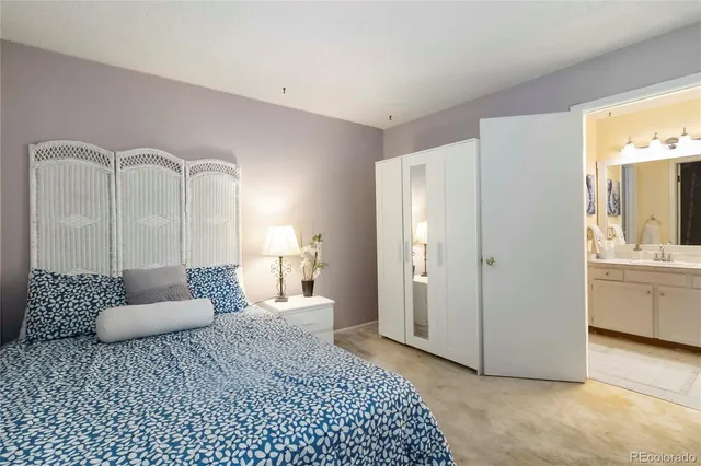 a bedroom with a bed and a couch