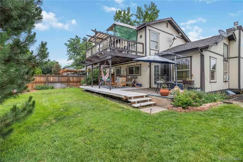 a front view of a house with garden and a patio
