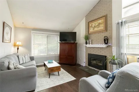 a living room with furniture flat screen tv and a fireplace
